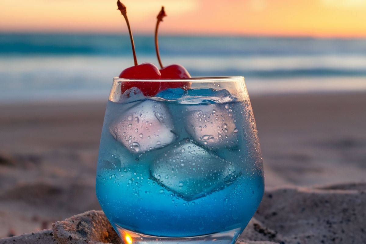 Bright blue Hawaiian Punch served in a tropical-themed glass with a slice of pineapple