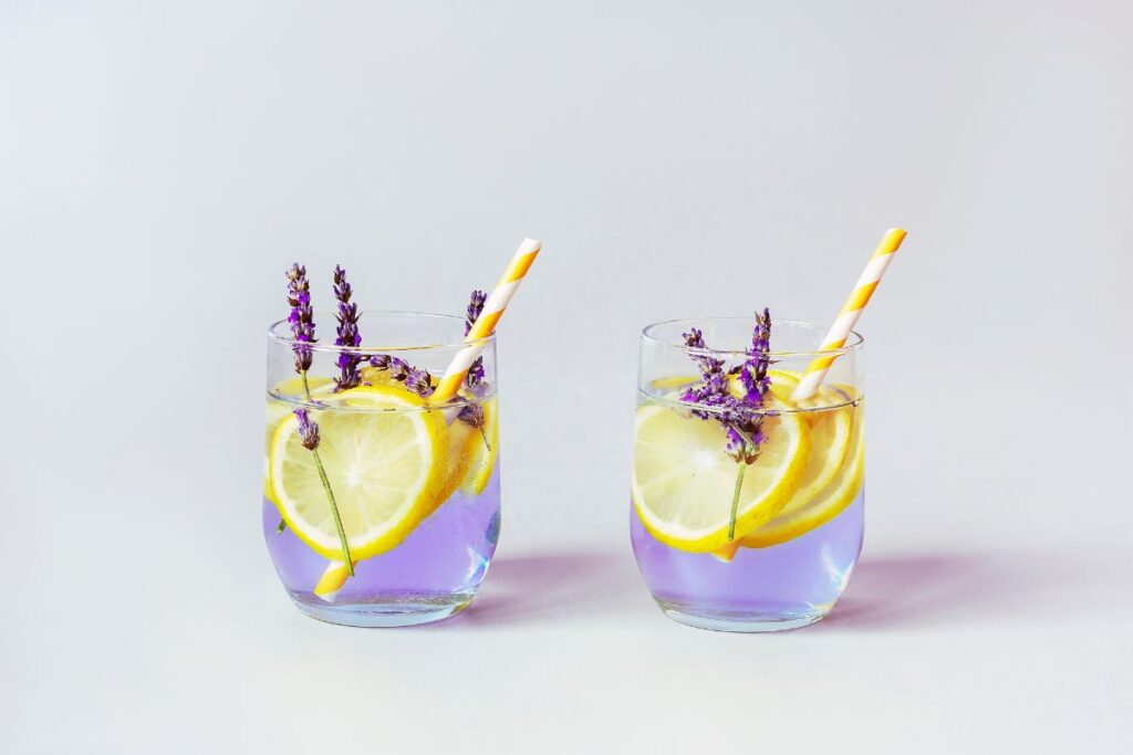 A refreshing lavender lemonade with lavender sprigs and lemon slices.