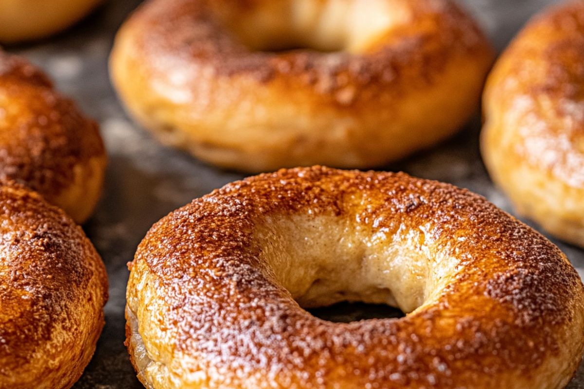 Freshly baked sourdough bagels with a golden crust, showcasing their chewy texture and natural fermentation process.