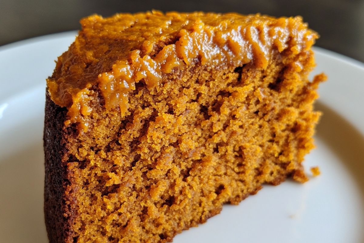 Moist pumpkin cake with a slice cut, revealing a dense and soggy center